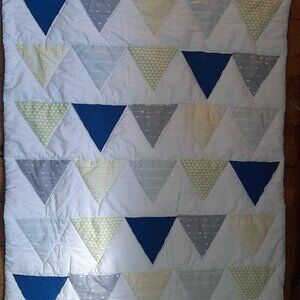 Two baby blankets, one crib size and a cotton crib sheet.